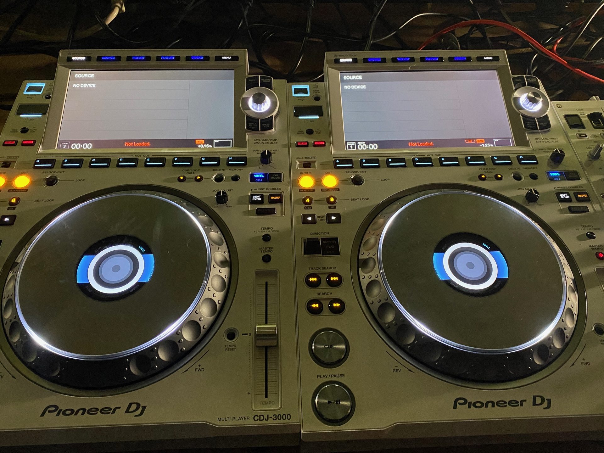 A pair of Pioneer DJ CDJ-3000 players linked in a booth, screens lit, before a set in Dallas