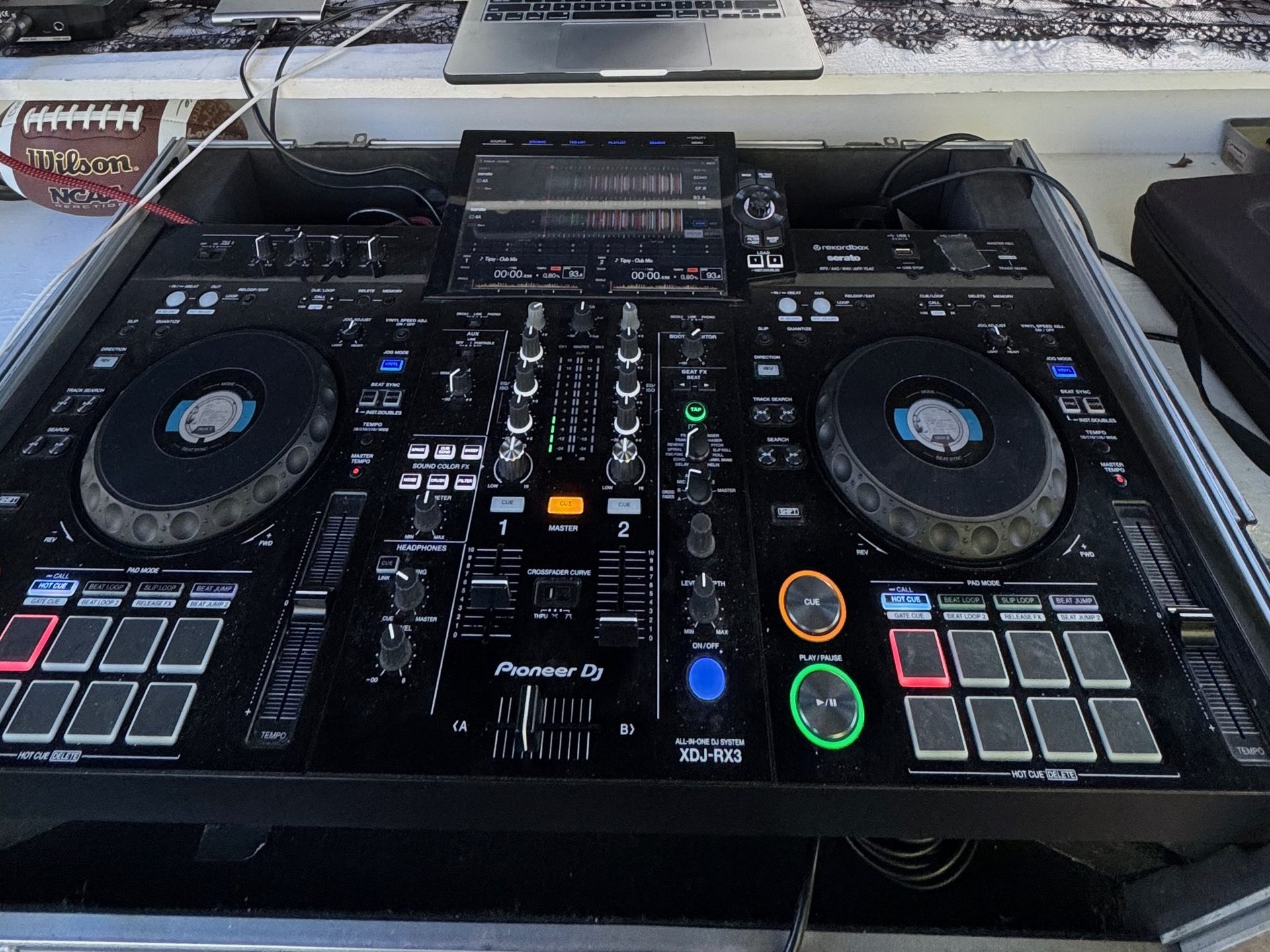A Pioneer DJ XDJ-RX3 all-in-one system in its case at an outdoor DFW reception