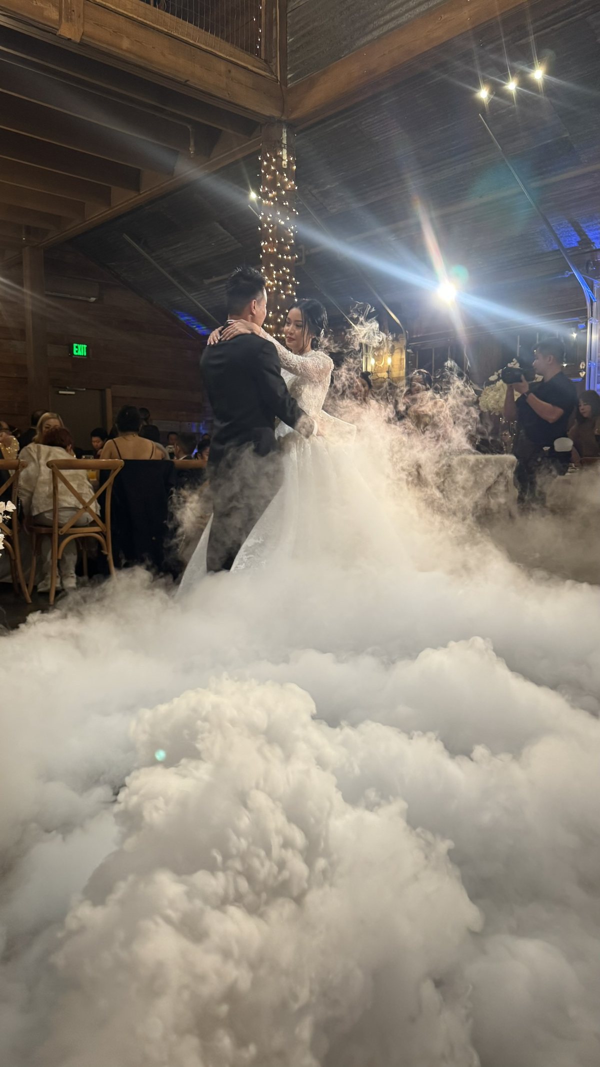 A couple dancing inside a low cloud of dry ice fog lying flat on the floor